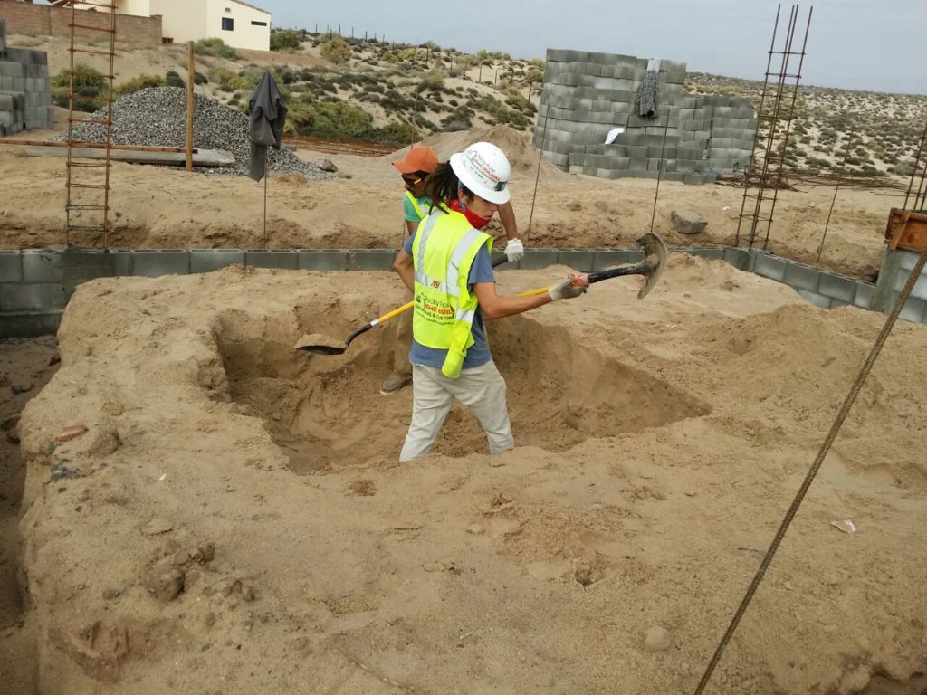 Workers excavate the soil in Puerto Peñasco
